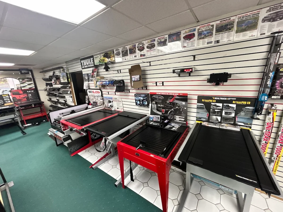 Retractable and roll-up tonneau cover displays on the showroom floor in Kearny Mesa